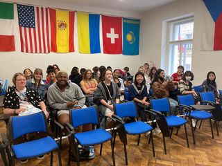 Students sitting in classroom with world flags above their heads