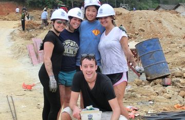 Interns wearing hardhats at a community development site