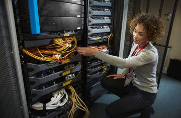 A female intern works on a computer server