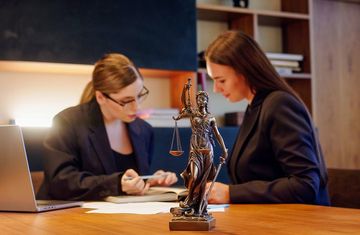 A lawyer and an intern reviewing documents in an office