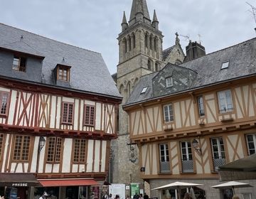 Half-timbered houses with a church in the background