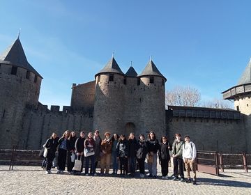 Students posing in front of a castle in France