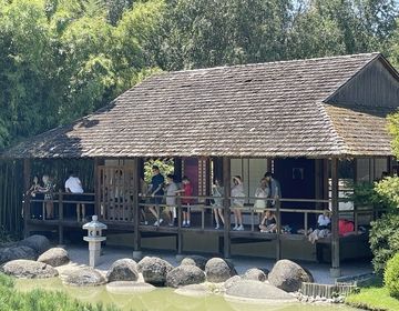 students on the porch of a Japanese house in a garden