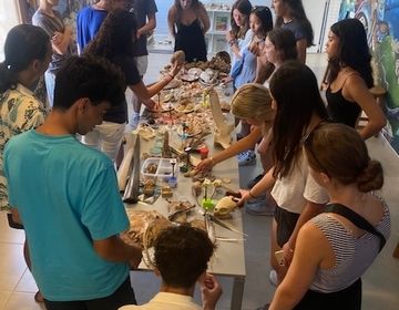 a photo of the students touching different shells 