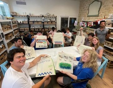 Students hold up their new tote bags!