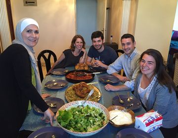 Students at the table with their host family