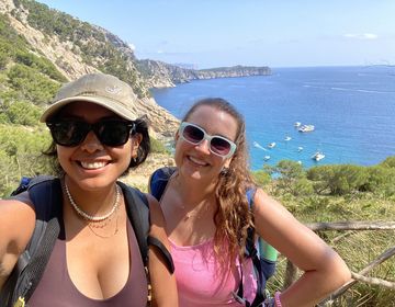 Students smiling by the ocean on a camping trip in Spain