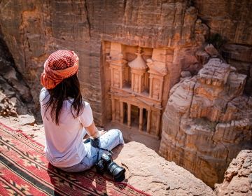 Student with camera sitting above Petra