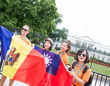 employees with flags by white house