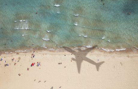 airplane shadow on beach abroad