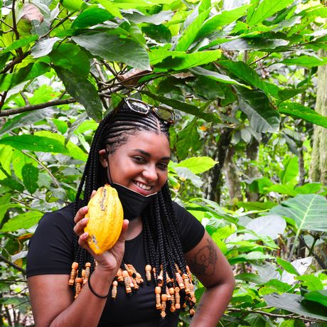 legon student holding a cocoa pod