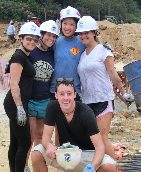 Interns wearing hardhats at a community development site