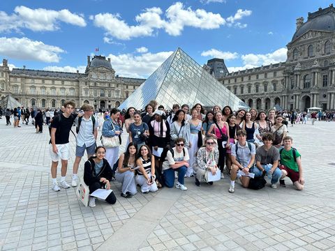 Group of high school summer students in front of the Louvre