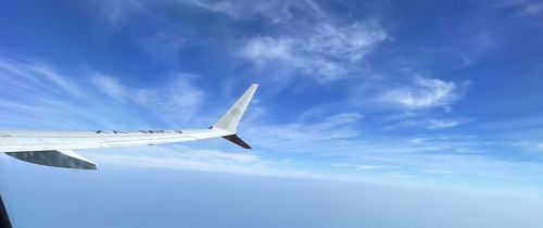 Shot of an airplane's wing out of a plane window