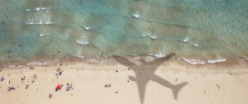 airplane shadow on beach abroad