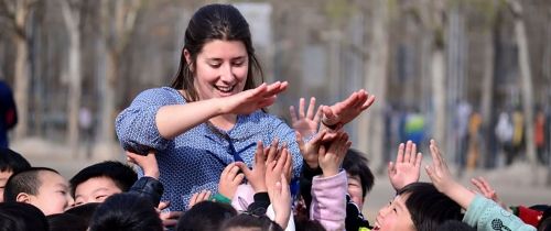 Teacher high-fiving her students