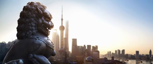 shanghai temple lion in front of the city skyline