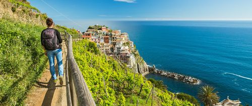 italy_woman-hiking-on-the-path-in-vineyard-near-manarola-village.jpg