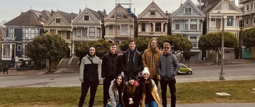 Students in front of houses in San Francisco on a cloudy day 