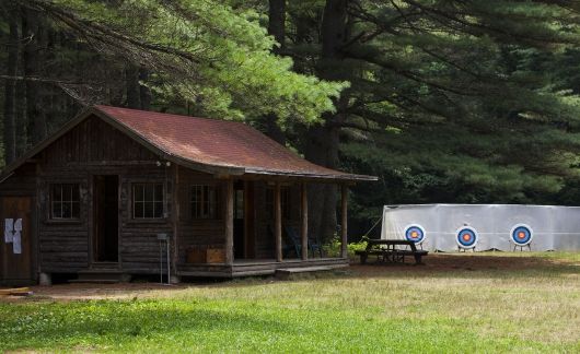 Archery range beside cabin at summer camp