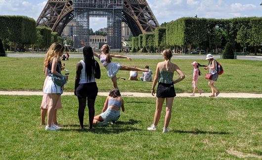 High school students frolicking by the Eiffel Tower