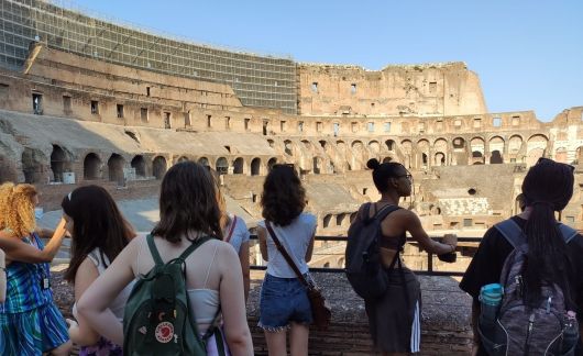 High school students looking out on interior of colosseum in Rome