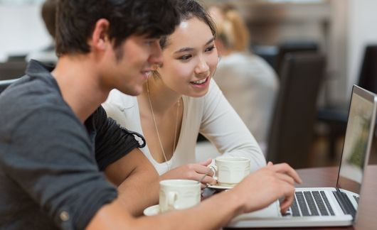 2 students working over laptop