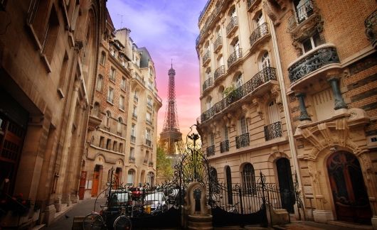 paris view of eiffel tower surrounded by buildings at sunset