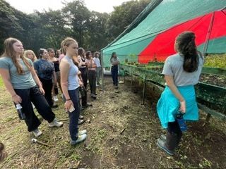 Bio teacher Ana explaining the compost and the green house. 