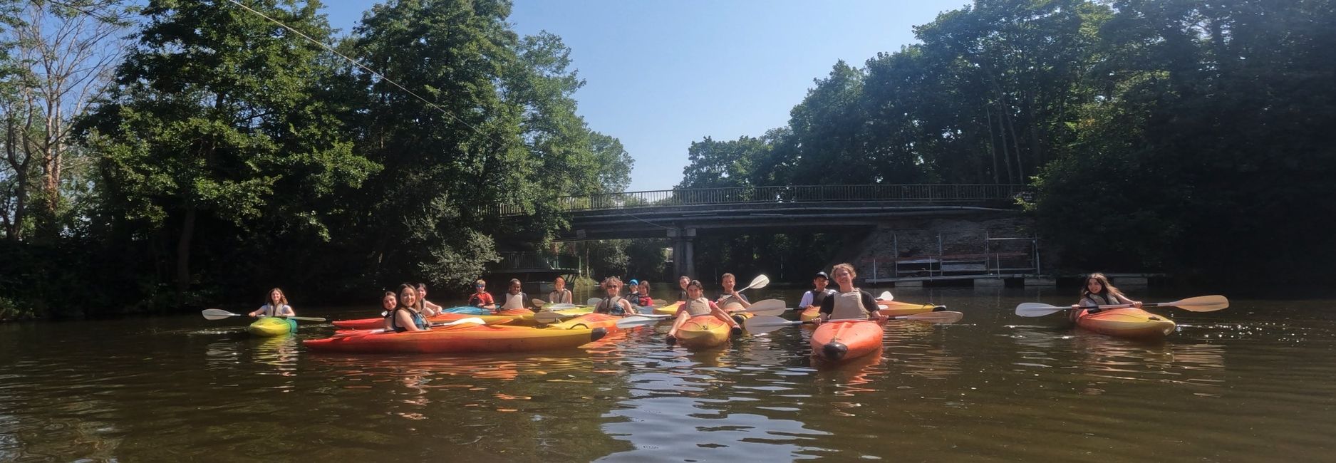 Kids kayaking on a river