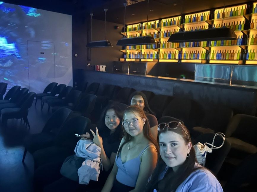 A group of HSSA Language and Culture students sit in the viewing room to watch the light show on a projection screen. 