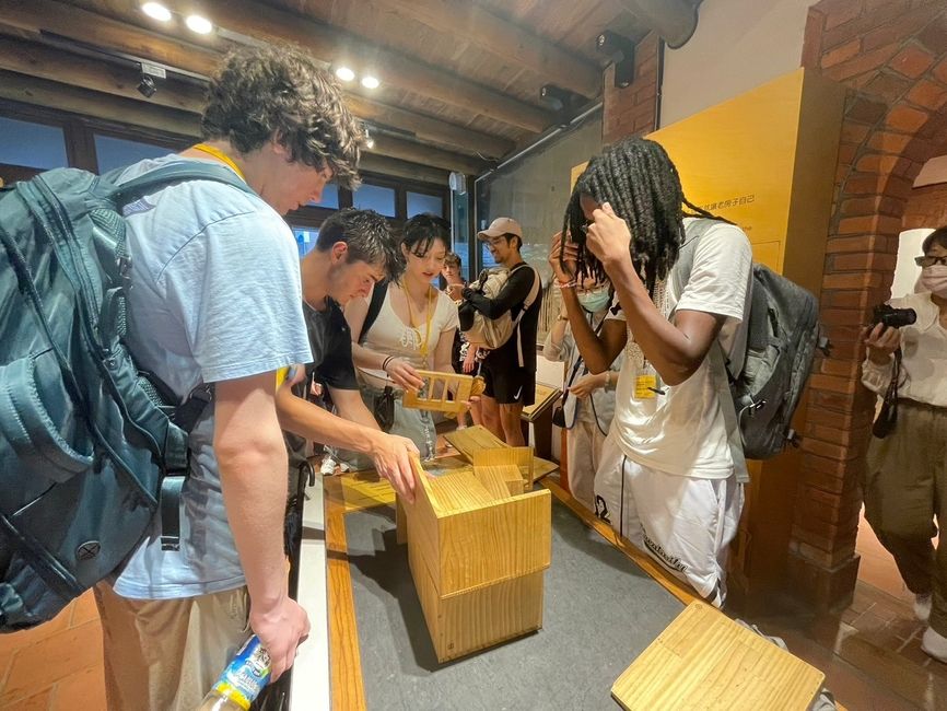 A group of students trying to rebuild and take apart a building influenced by Japanese architecture