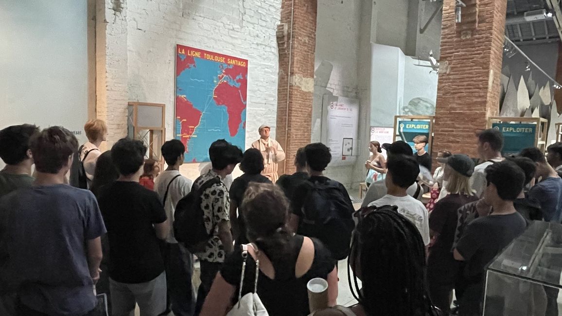 Students listen to a tour guide at the museum