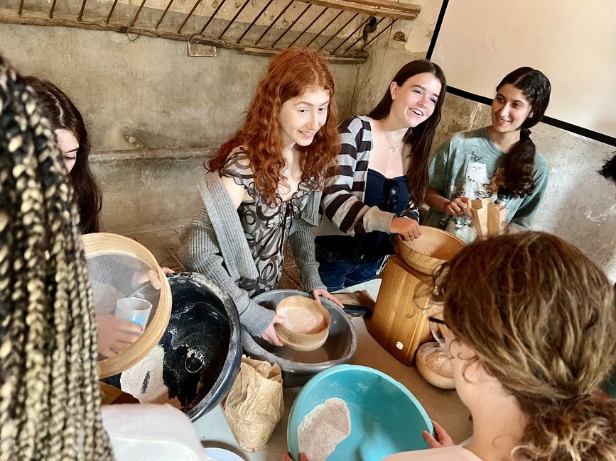 teen girls sifting flour