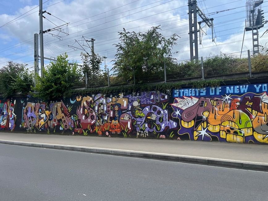 Murals on the wall along the train tracks from the 2023 Urban Art Festival in Rennes.