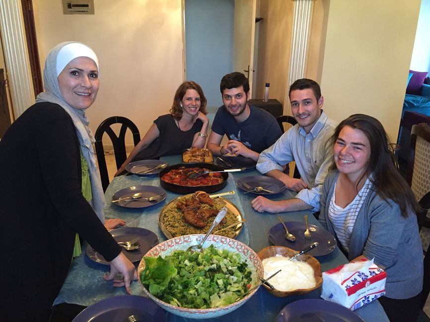 Students at the table with their host family