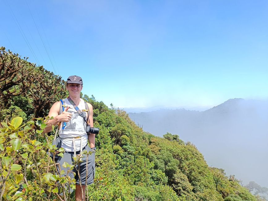 High school student giving a thumbs up at the top of Cloud Forest Mountain