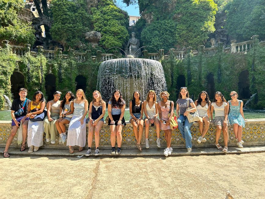 Students sitting in front of fountain in Rome