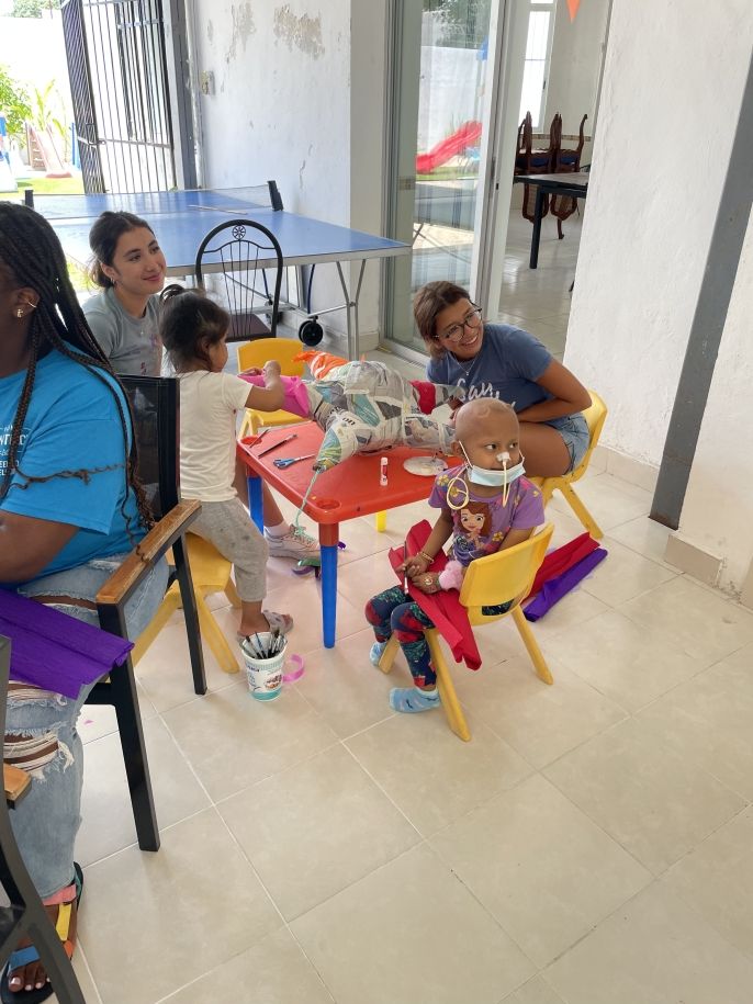 Jazzy and Alyssa working with the children at AMANC