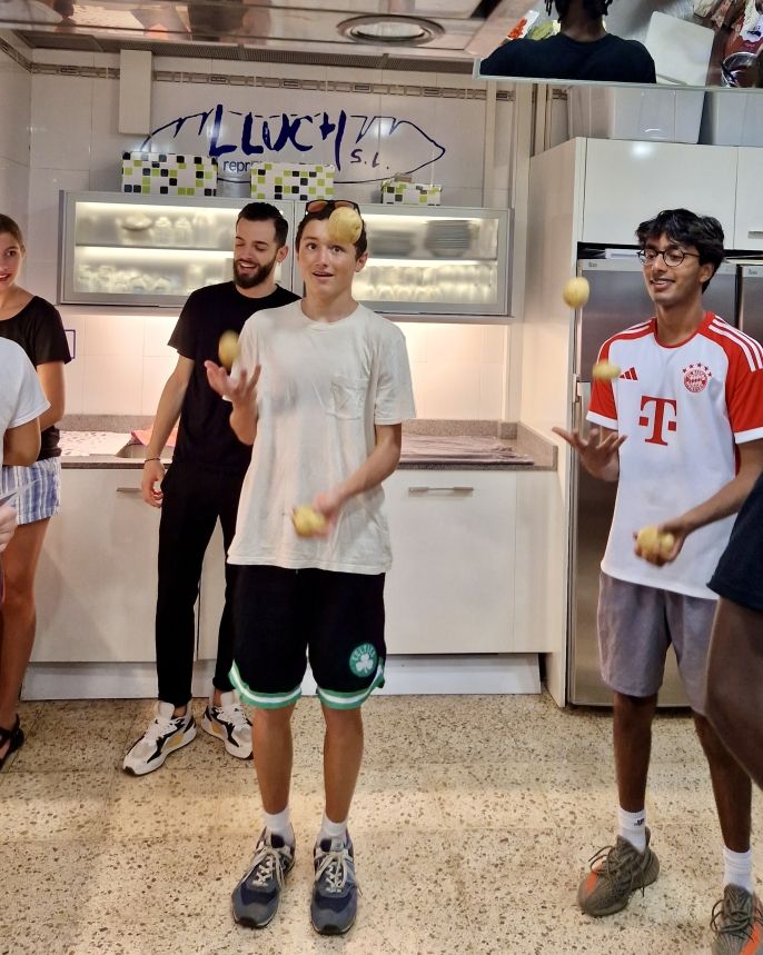 Gus & Ajax juggling some potatoes to provide comic relief in the high stress of the professional kitchen