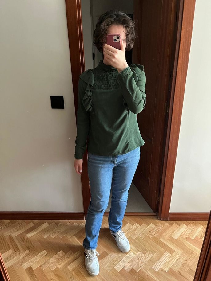 The author wearing a green shirt and jeans