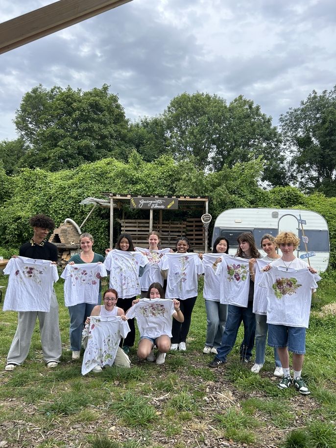 AM group students hold up their finished T-shirts