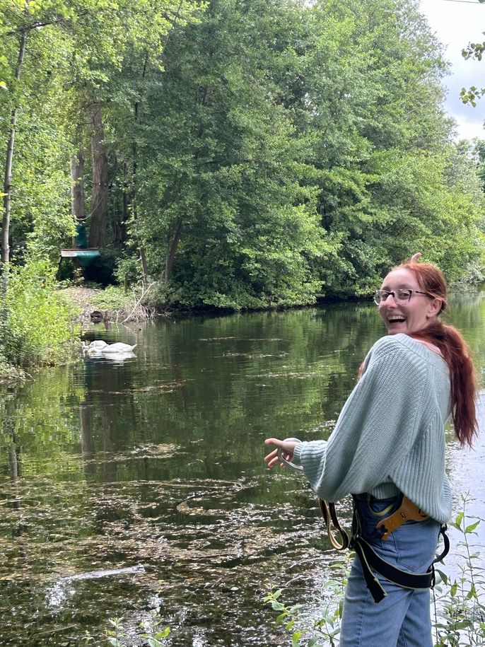 Fashion and Design student Nina Lalic points to some swans swimming in the lake. 