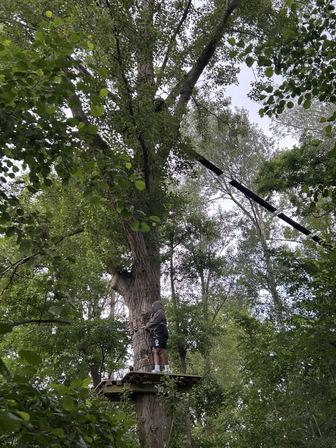 Fashion and Design student, Jola Adebiyi pauses between obstacles on a platform in the trees.