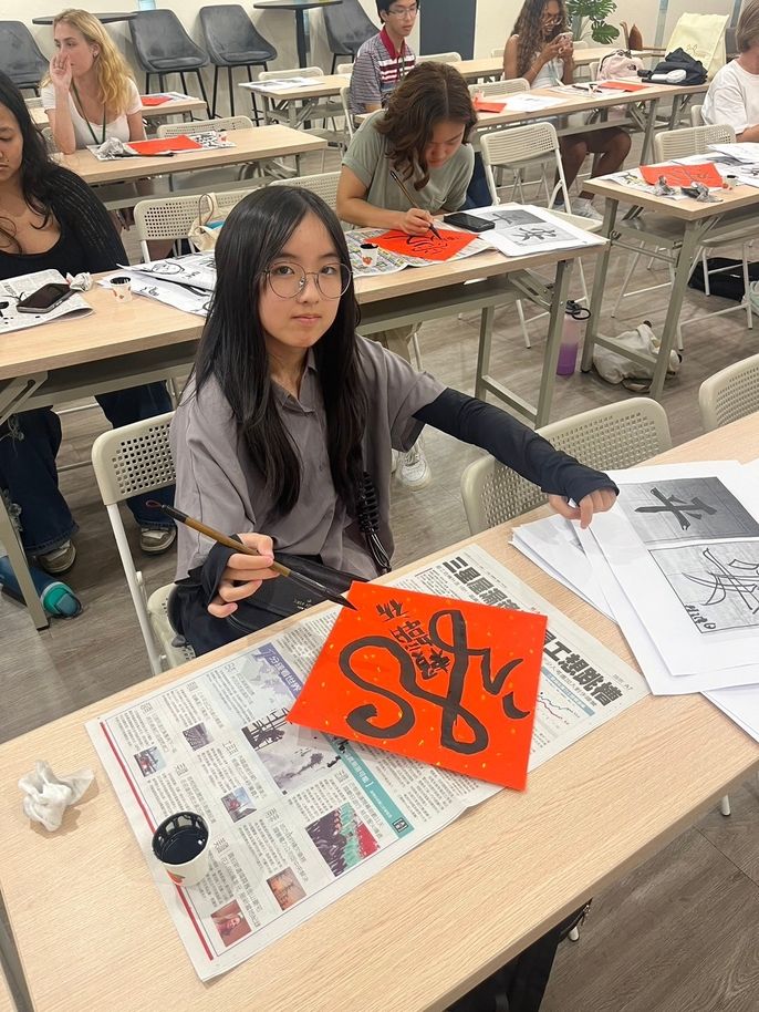 Girl practicing calligraphy and making a red spring couplet 