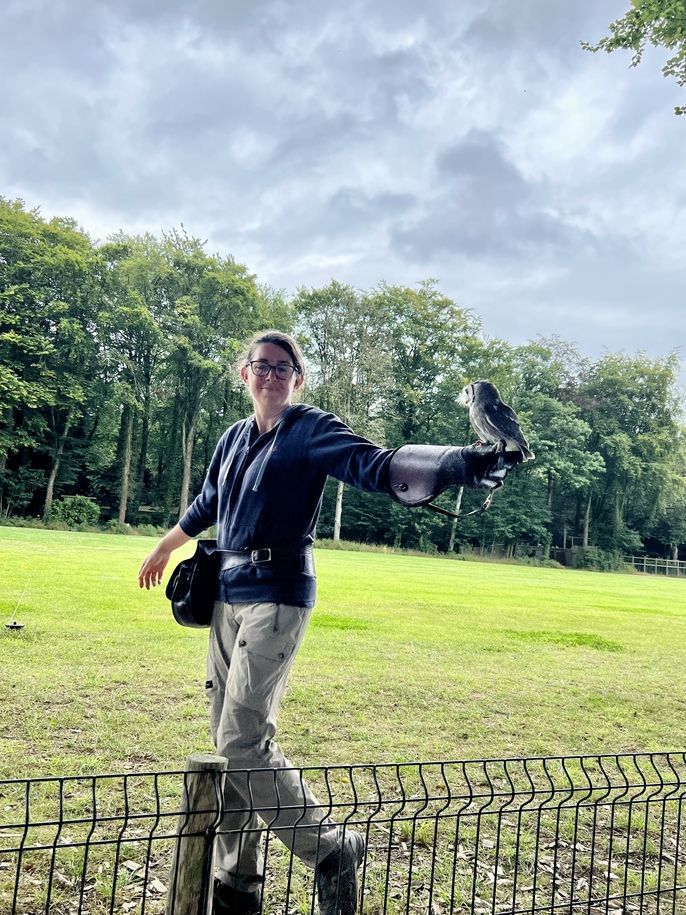 Falconer with an owl on her arm