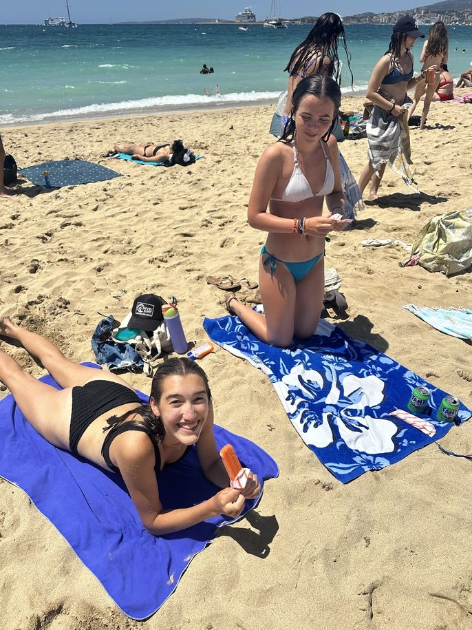 Students enjoying an ice pop on the beach! 