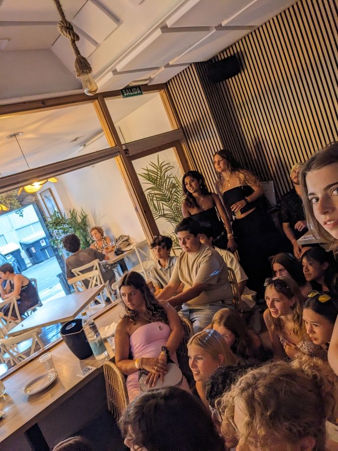 A crowd of students watches a screen