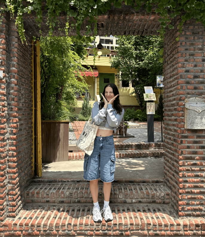 Happily posing in front of a Kiki's Delivery Service Cafe!