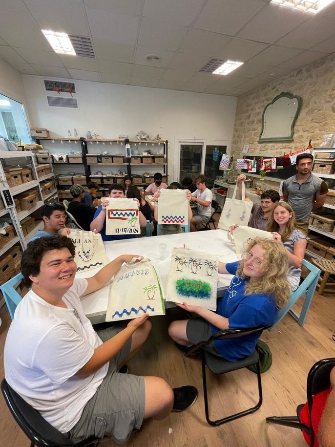 Students hold up their new tote bags!